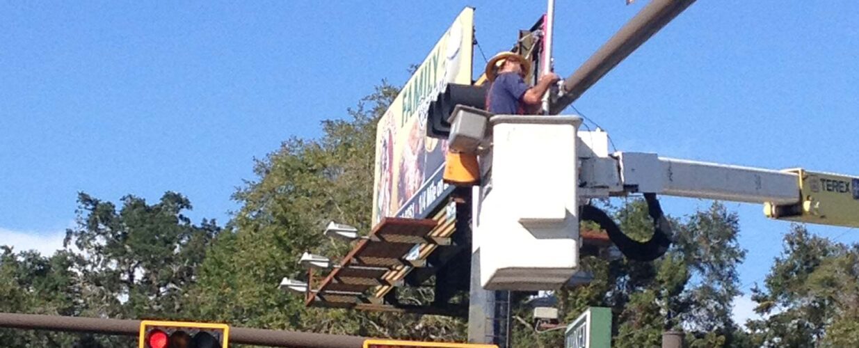 closeup of crew member working on traffic light